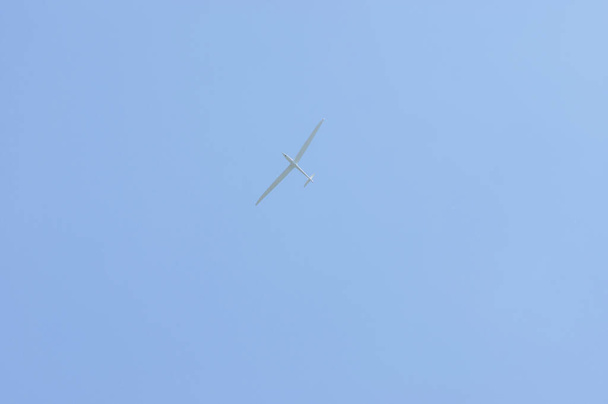 White glider plane in flight with a clear blue sky - Photo, Image