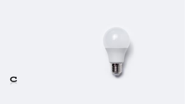 Close-up of glowing light bulb near text of creative idea. Business and education concept. Stop motion animation photography. - Footage, Video