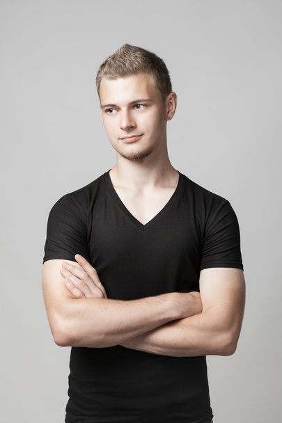 young man with folded arms isolated on light background - Foto, Imagem
