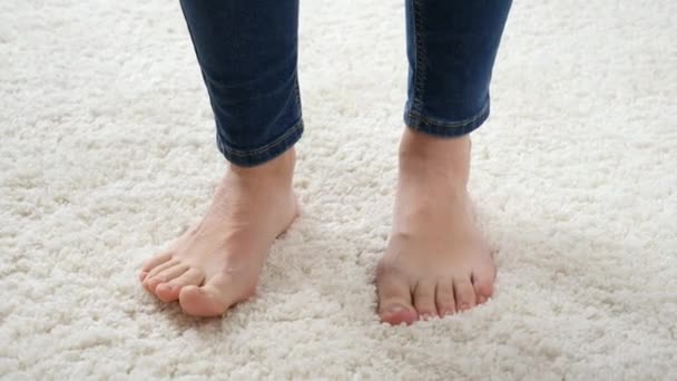 Closeup of barefoot mother waiting for her son running around her on white carpet - Footage, Video