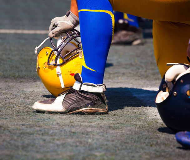 athlete's foot in his hand helmet  - Фото, зображення