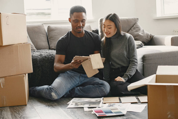 Diverse couple choosing design for new flat - Photo, image