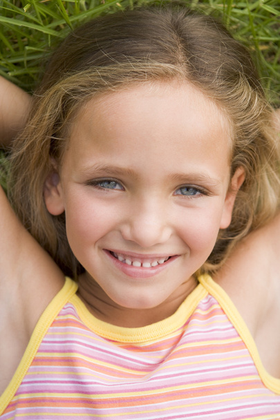 Young Girl Lying Down On The Grass - Foto, Bild