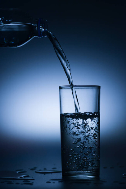 Pouring pure drinking water from a bottle into glass, copy space - Photo, Image