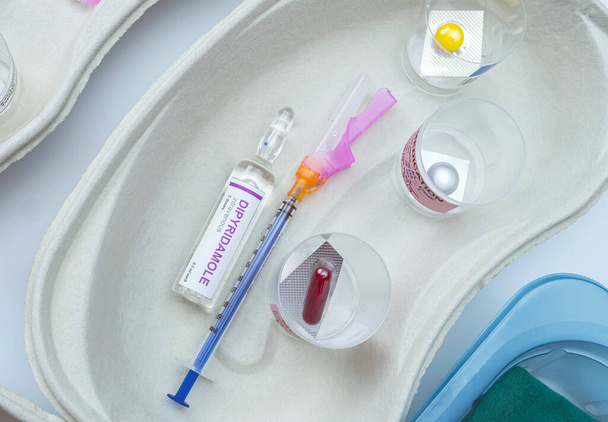 Шприцы, загруженные лекарствами рядом с медицинскими ампулами, подготовленными в больнице, концептуальный образ - Фото, изображение