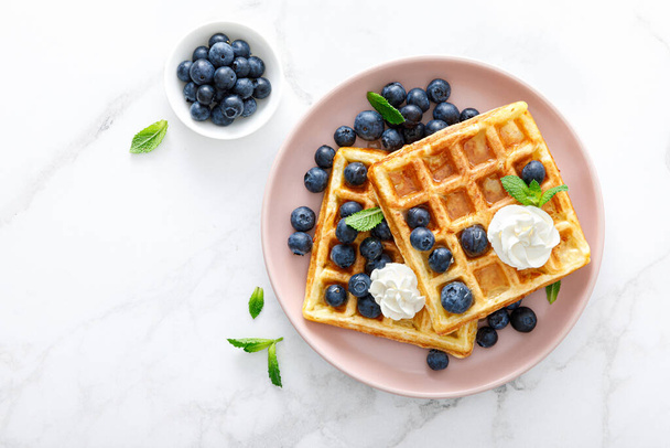 Waffles with cream cheese and fresh blueberries, healthy food, breakfast. Waffles with berries. - Foto, Imagen