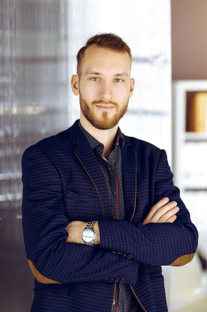 Bearded friendly adult businessman looking at camera. Business headshot or portrait in sunny office - Foto, Bild