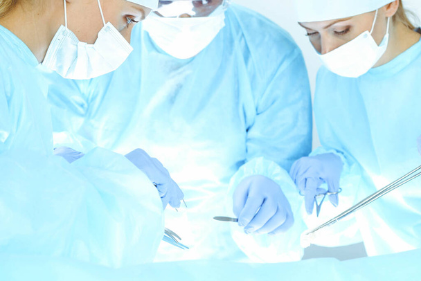 A group of surgeons is operating at the hospital. Health care concept - 写真・画像