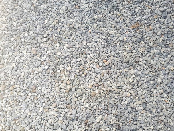 Gravel stones flooring pattern surface texture. Close-up of exterior material. Small road stone background, dark gravel pebbles stone texture - Photo, Image