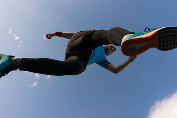 Sportsman runs and jump into the sky - Fotoğraf, Görsel