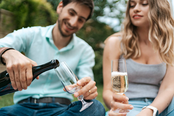 Couple drinking sparkling wine with strawberries - Fotó, kép