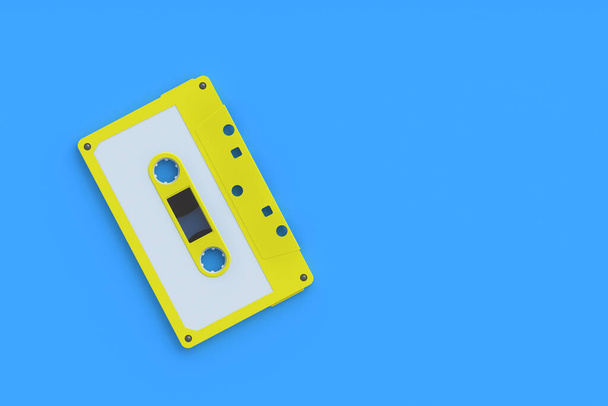 Single vintage audio cassette tape of yellow color on blue background. Music storage. Retro cartridge. Copy space. 3d render - Foto, afbeelding