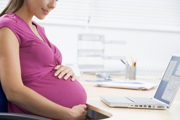 Pregnant woman at work - Фото, зображення