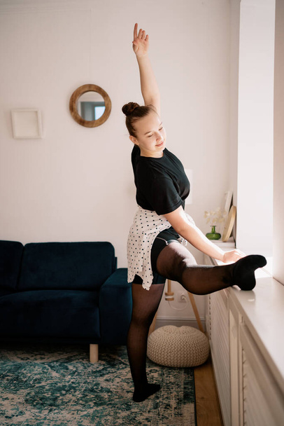 Pretty young lady practicing ballet online - 写真・画像