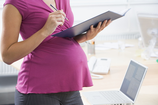 Pregnant woman at work - Fotó, kép