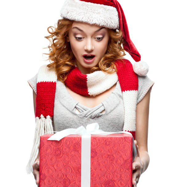 surprised young woman holding gift on white - Foto, afbeelding