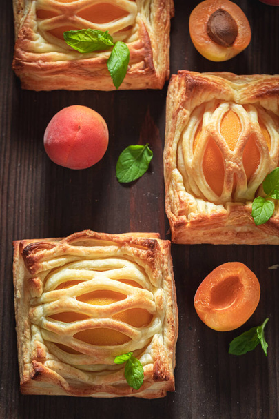 Sweet puff pastry with sugar and peaches. French juicy dessert. French cuisine. - Foto, imagen