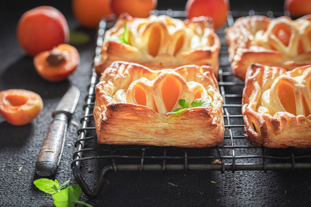 Sweet puff pastry with peaches and mint. Unique yummy cake. French cuisine. - Foto, imagen