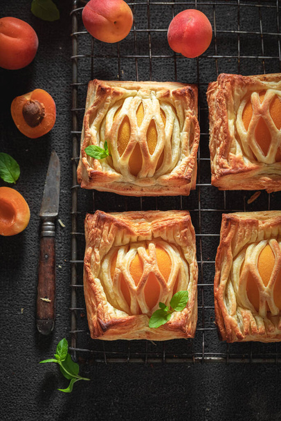 Tasty puff pastry with sugar and peaches. Unique yummy cake. French cuisine. - Foto, imagen