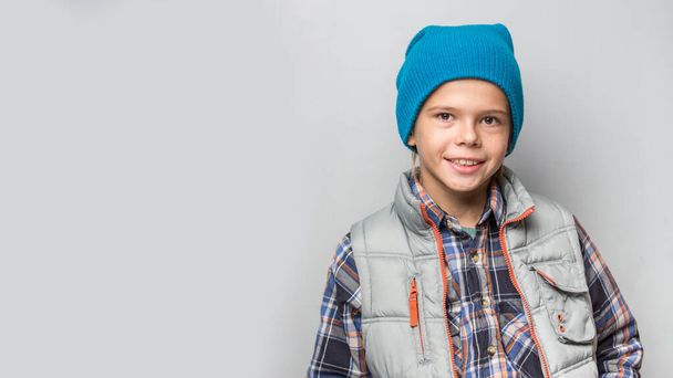 Portrait of the boy wearing autumn ccasual clothes over grey background - Fotografie, Obrázek