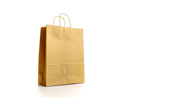 Brown paper bag texture. Kraft recycle package with empty blank space for design mockup isolated on white background. Delivery service concept. Copy space. Advertising area - Photo, image
