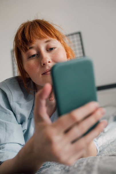 Excited millennial female shooting herself with pretty faces on smartphone - Valokuva, kuva