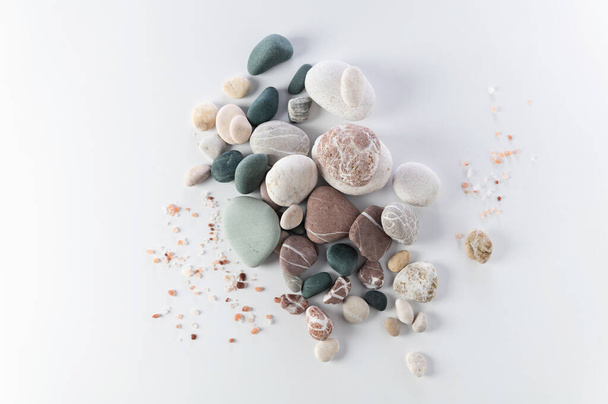 body and soul care banner, colored round stones, sea salt on white background, top view, empty space for text - Photo, Image