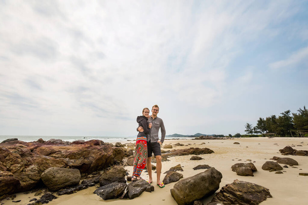 Happy tourist couple on Son Hao beach, Quan Lan island, Bai Tu Long Bay, Vietnam. Seaside scenery photo taken in south east Asia, Ha Long area. - Photo, Image