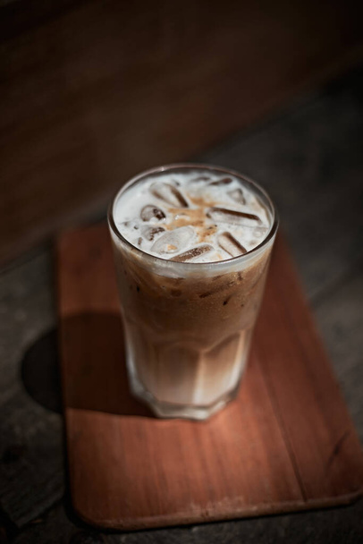 iced latte coffee in a glass with cold milk. - Фото, изображение