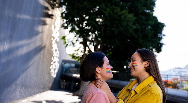 lesbian girls having fun painting themselves and with the lgtb flag on pride daylgtb concept - Photo, image