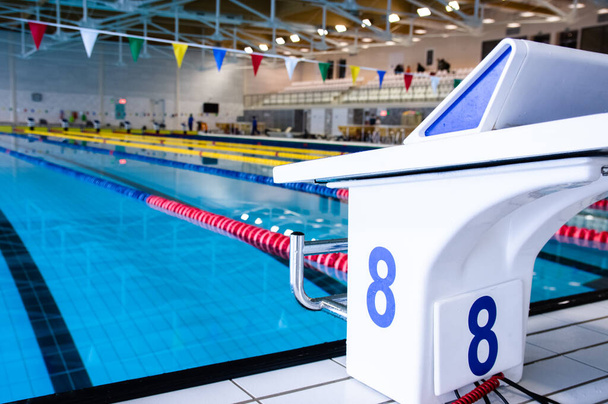 Aligned swimming starting block and platform with number - Foto, imagen