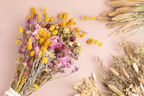 Composing bouquet of dry flowers and herbs, trendy interior decoration, artisan florist shop - Fotó, kép