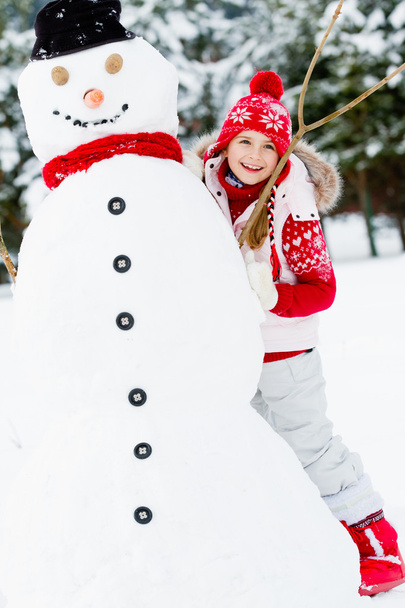 Winter, snowman - lovely girl has a fun in snow - Photo, Image