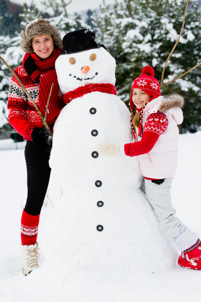 Winter fun, snowman and happy family - Photo, Image
