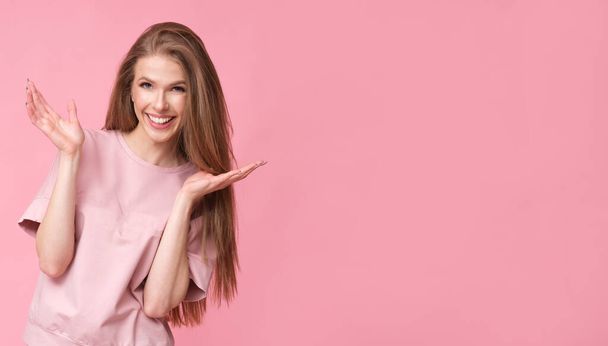 Positive long hair woman on pink background. - Foto, imagen