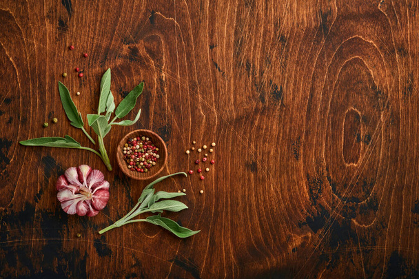 Food background. Spices, herbs, sage leaf, multicolored pepper and kitchen tools. Top view. Space for your text. Rustic style. - Foto, imagen