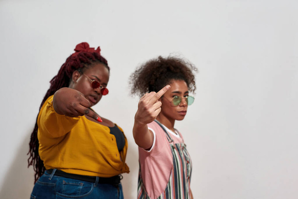Afro women showing middle fingers and do not care about others opinion - Fotografie, Obrázek