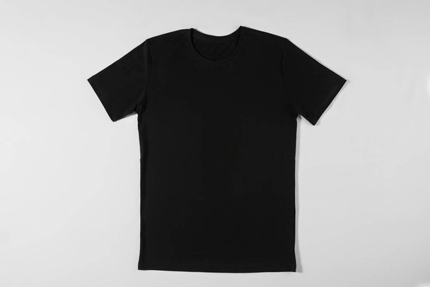 Black beautiful T-shirt on a light background - Фото, зображення