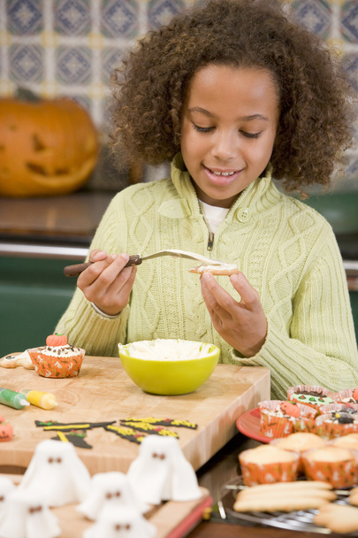 Young girl at Halloween making treats and smiling - Fotoğraf, Görsel