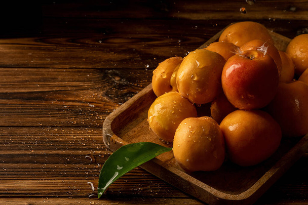 Delicious apricots on a dark wooden background. - Foto, afbeelding