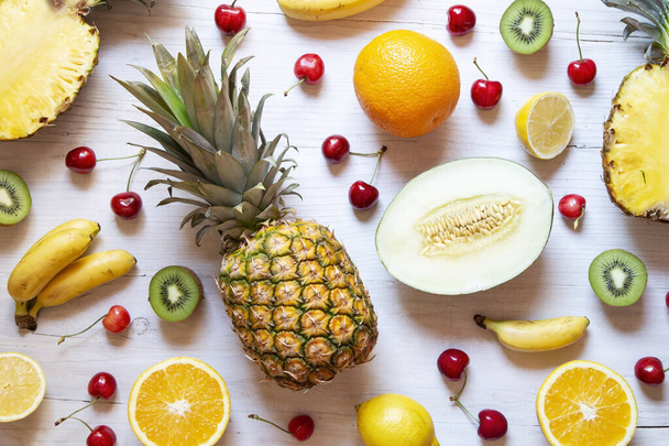 Tropical fruit on white wooden background - Foto, Bild