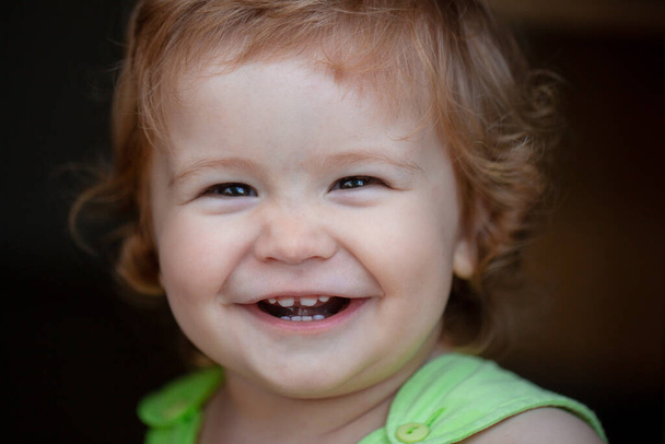 Portrait of a happy laughing baby. Close up positive kids face. Smiling infant, cute smile. - Zdjęcie, obraz