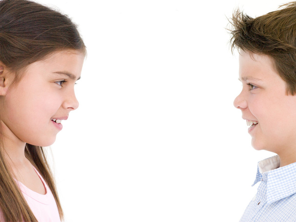 Brother and sister looking at each other smiling - 写真・画像