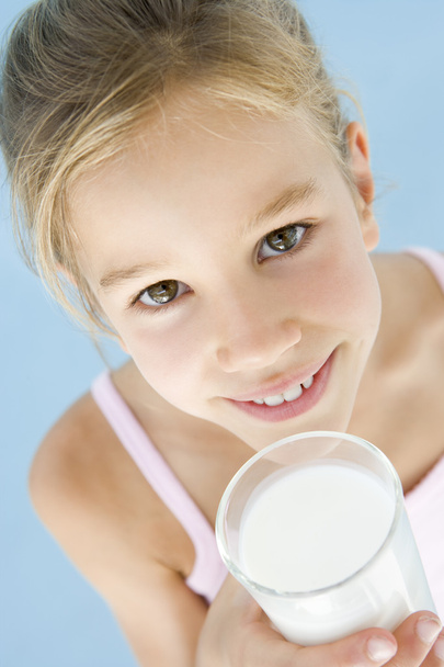 Young girl with glass of milk smiling - Foto, Imagen