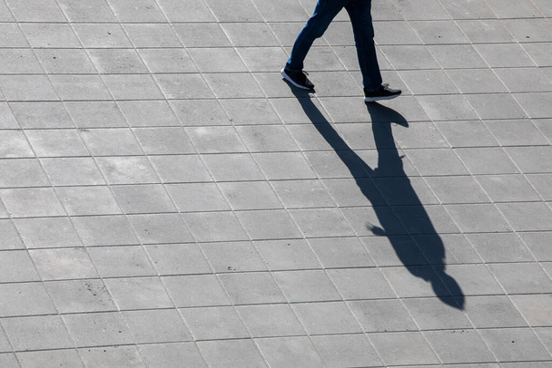 conceptual photography shadow from a guy on a pavement, top view - Foto, Imagen