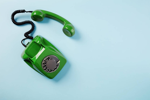 Rotary green phone on blue background - Foto, Imagen