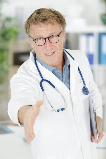 doctor shaking hands at hospital - Photo, image