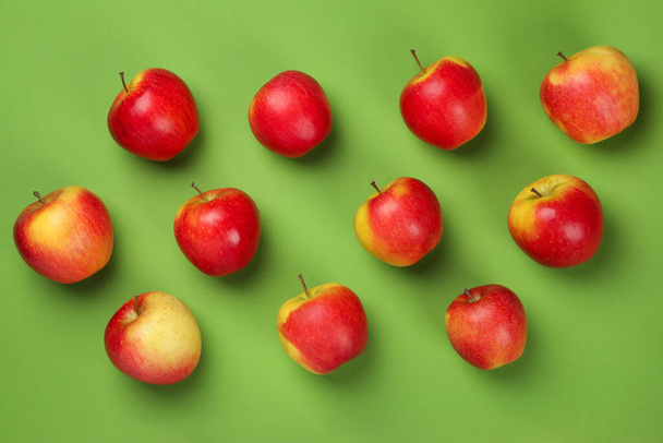 Ripe apples on green background, top view - Photo, Image