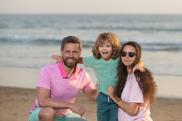 happy family portrait of mother father and son kid on malibu beach in summer vacation, family - Photo, Image