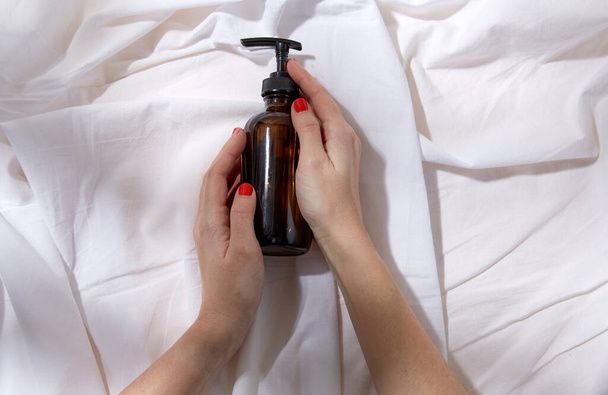 hands with bottle of shower gel or liquid soap - Valokuva, kuva